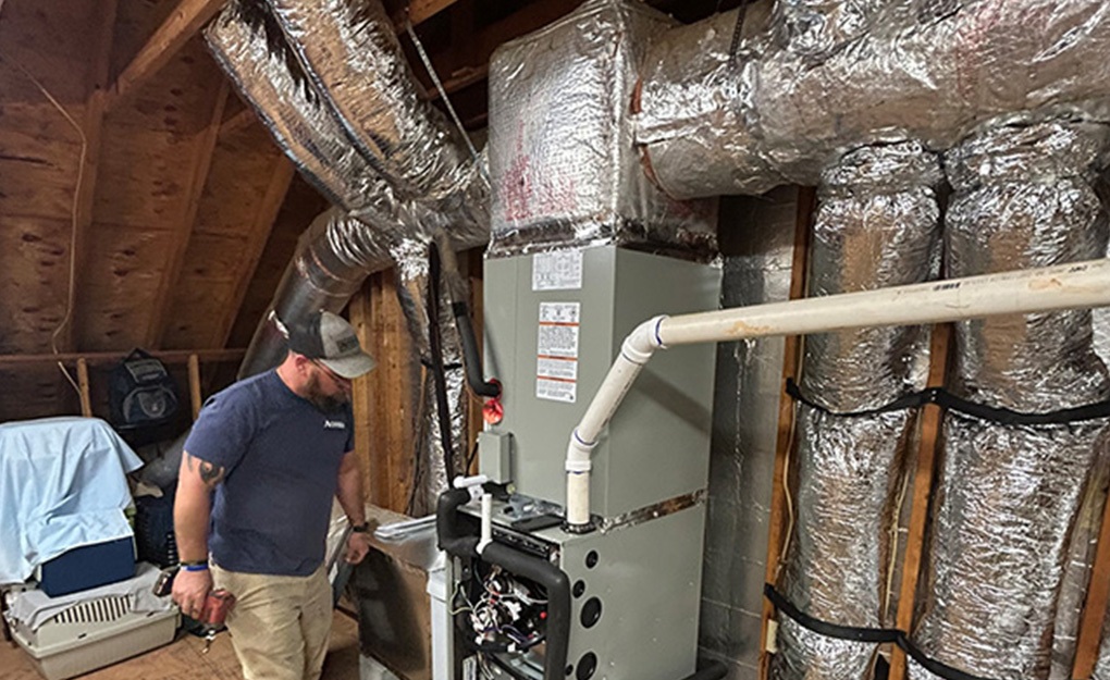 tech with drill at heating unit - rec