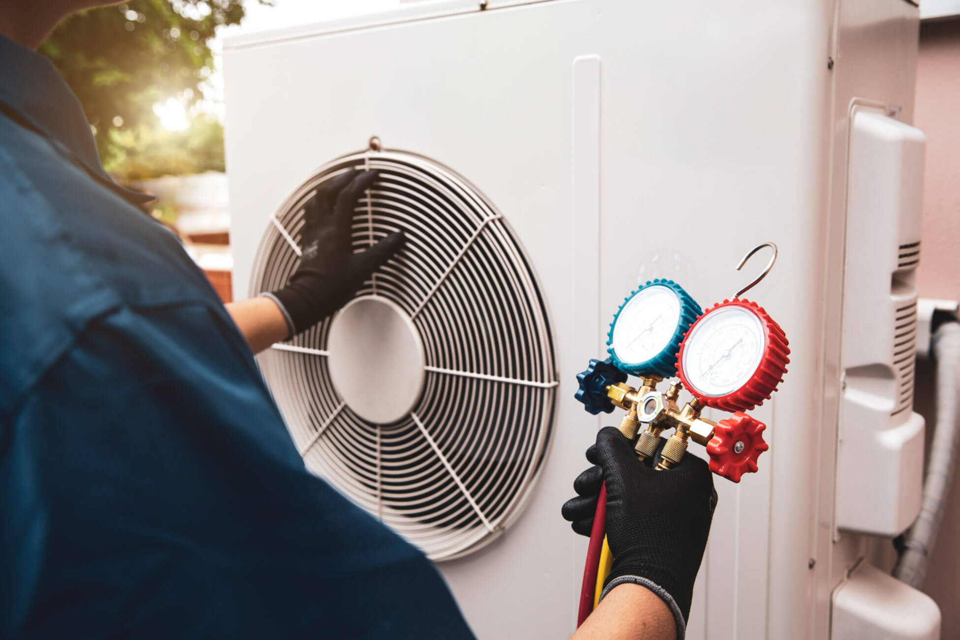HVAC system service technician checking refrigerant and filling industrial air conditioner after duct cleaning maintenance
